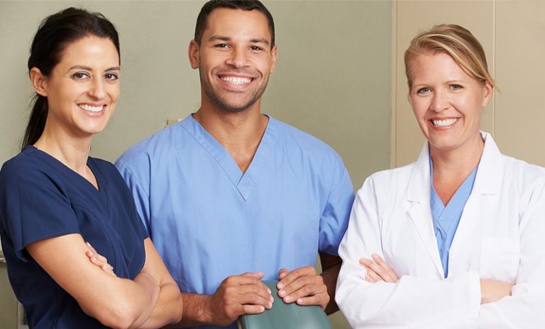 Three young, smiling medical professionals