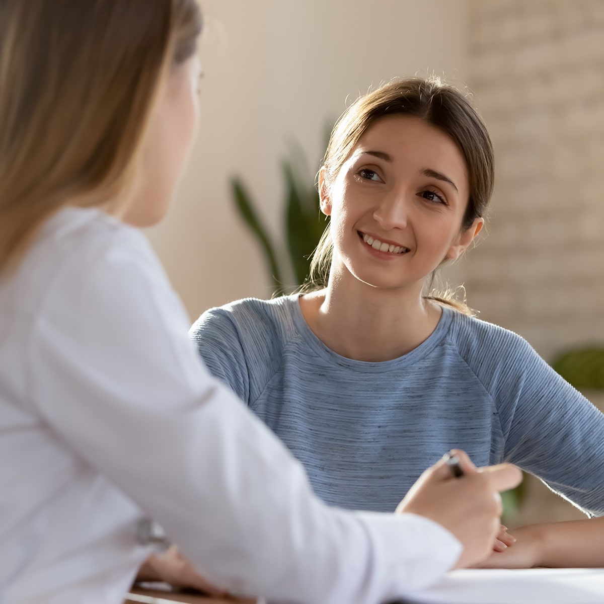 Young female patient speaks with counselor.